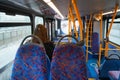 London, United Kingdom - February 01, 2019: Anonymous young female passenger travelling in otherwise empty public transport bus,