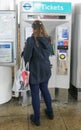 London, United Kingdom - February 01, 2019: Anonymous young woman purchasing travelcard / ticket for DLR Docklands Light Railway