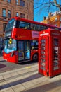 London, United Kingdom, February 8, 2022: the famous red double-decker bus and the red telephone booth on a London