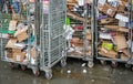 London, United Kingdom - February 04, 2019: Metal cage on wheel with various paper rubbish - mostly empty boxes - to be recycled,