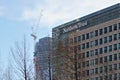 London, United Kingdom - February 03, 2019: Northern Trust UK branch offices at Canary Wharf. Tall construction crane in Royalty Free Stock Photo