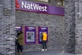 London, United Kingdom - February 02, 2019: People withdrawing money from Natwest ATM. National Westminster Bank is considered one
