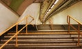 London, United Kingdom - February 01, 2019: Stairs leading into tunnel illuminated by neon lights inside London underground train Royalty Free Stock Photo