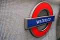 London, United Kingdom - February 02, 2019: Waterloo underground station illuminated sign at wall of tube stop. Traditional red, Royalty Free Stock Photo