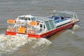 A City Cruises tour boat sails on the Thames River in London, UK Royalty Free Stock Photo