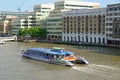 A City Cruises tour boat sails on the Thames River near, London, UK Royalty Free Stock Photo