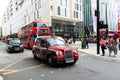 Legendary London taxi cab and red bus on the streets of London Royalty Free Stock Photo