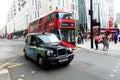 Legendary London taxi cab and red bus on the streets of London Royalty Free Stock Photo