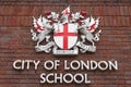 Coat of arms of City of London on facade of City of London School, London, United Kingdom