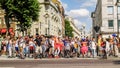 Large group diverse people meet-up on city street for a roller-blade street outing