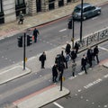 High perspective view of officer worker pedestrians in the City of London crossing the street