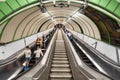 London, United Kingdom - May 12, 2019: View of escalators and travelers inside London Underground. Royalty Free Stock Photo