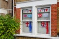 London, United Kingdom - May 04, 2020: Windows of Lewisham house decorated with British and England flags and VE 75 sign to