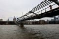 The Millenium Bridge and Saint Paul Cathedral on a typical cloudy day in London Royalty Free Stock Photo