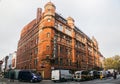 cars and traffic condition in front of vintage Palace Hotel building in London