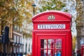 LONDON, UNITED KINGDOM - NOVEMBER 13, 2021: Famous red telephone booth on a street of London