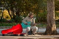 London, United Kingdom - November 18th, 2006: Unknown busker plays guitar and signs at Thames riverside. Street performers are pe