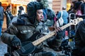 London, United Kingdom - November 25th, 2006: Unknown busker plays bass guitar and signs at Covent Garden. Street performers are