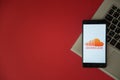 Soundcloud logo on smartphone screen placed on laptop keyboard.