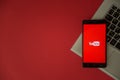 Youtube logo on smartphone screen placed on laptop keyboard. Royalty Free Stock Photo