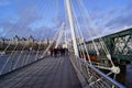 London, United Kingdom: people walking on the Golden Jubilee Bridge