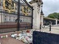 London, United Kingdom - September 9 2022: Flowers in front of the gates of Buckingham Palace to honor the memory of the Royalty Free Stock Photo
