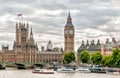 London - view of Big Ben clock tower, Houses of Parliament and Thames river with boats.