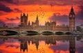 London Westminster and Big Ben reflected on the thames at sunset with birds flying over the city