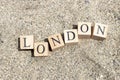 London word on wood cubes . On the beach sand by the sea Royalty Free Stock Photo