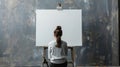 A lone artist before a blank canvas in a minimalist studio embodying originality and passion the quintessence of creativity Royalty Free Stock Photo