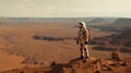 A lone astronaut standing on the surface of the red planet Mars. He looks around and observes the breathtaking view. Royalty Free Stock Photo