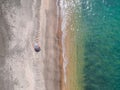 A lone beach umbrella on the sand beach, flat aerial view for background