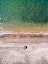 A lone beach umbrella on the sand beach, flat aerial view for background