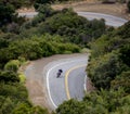 A lone biker drives along winding Mulholland highway in southern California. Royalty Free Stock Photo