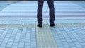 Lone blind man detecting tactile tiles, walking to pedestrian crossing safe road Royalty Free Stock Photo