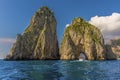 A lone boat sails through the tunnel of love sea arch in the Faraglioni rocks on the eastern side of the Island of Capri, Italy Royalty Free Stock Photo