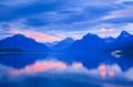 Lone Boat and Sunrise Colors on Calm Mountain Lake Royalty Free Stock Photo