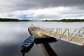 Lone boat tied to small pier on Lough Leane, the largest and northernmost of the lakes of Killarney National Park, County Kerry, I