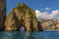 A lone boat in the tunnel of love sea arch in the Faraglioni rocks on the eastern side of the Island of Capri, Italy Royalty Free Stock Photo