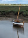 Lone boat on water, Blakeney, North Norfolk coast, East Anglia, UK