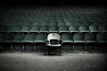 a lone chair in the center of a grandstand, surrounded by empty seats