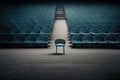 a lone chair in the center of a grandstand, surrounded by empty seats