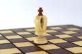 Lone chess white king on a chessboard over white background Royalty Free Stock Photo