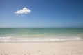 Lone cloud in a Blue sky over white sand of Tigertail Beach