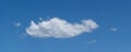 Lone cloud drifts across blue sky panorama