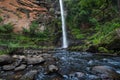 Lone creek falls with stone river flow in Sabie