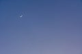 Crescent moon and Venus glowing in deep blue sky Royalty Free Stock Photo