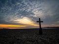 A Lone Cross On A Rocky Beach At Sunrise Royalty Free Stock Photo