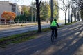 Lone cyclist wearing yellow reflective vest
