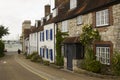 A lone elderly male walks down a street of picturesque terraced houses toward the marina in the village of Warsash.